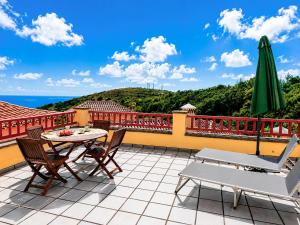 a patio with a table and chairs on a balcony at Emiliana in Puntallana