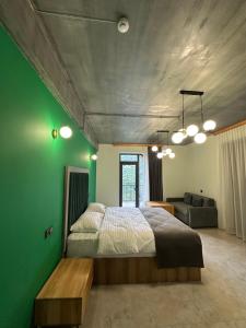 a bedroom with a bed and a green wall at Royal Forest Dilijan in Dilijan +21 photos