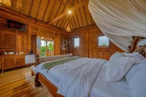 a bedroom with a bed in a room with wooden walls at Padiku Villa Semana Private Pool in Badung