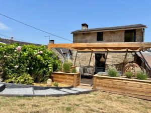 a house with a garden in front of it at La Chambrote - Maison, spa privatif & clim in Brive-la-Gaillarde