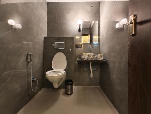 a bathroom with a white toilet and a sink at Hotel hk haridwar By hk guest house in Haridwār +16 photos