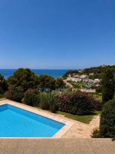 a swimming pool with a view of the ocean at Cala Crancs - Sea Views in Salou