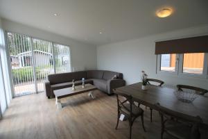 a living room with a couch and a table at Residence de Eese in De Bult