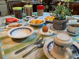 a table with plates and bowls of food on it at Merzuq House in Birżebbuġa