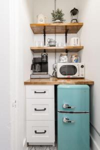 a kitchen with a blue refrigerator and a microwave at Chic Studio Apartment on Oglethorpe Square in Savannah