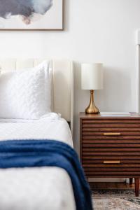 a bedroom with a bed and a nightstand with a lamp at Chic Studio Apartment on Oglethorpe Square in Savannah