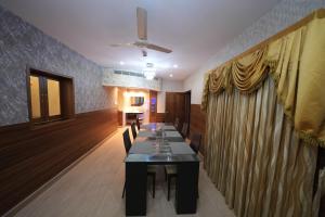 a dining room with a long table and chairs at Saj Earth Resort , Cochin Airport in Nedumbassery