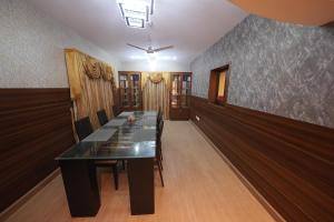 a conference room with a long table and chairs at Saj Earth Resort , Cochin Airport in Nedumbassery