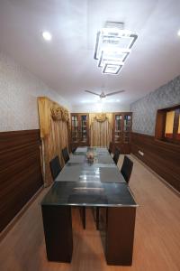 a large conference room with a long table and chairs at Saj Earth Resort , Cochin Airport in Nedumbassery +80 photos