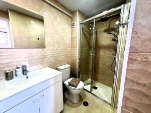 a bathroom with a shower and a toilet and a sink at Casa do Mar & Sesimbra Center View in Sesimbra +15 photos