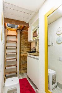 a small kitchen with a staircase in a tiny house at micro 3 in Volta Redonda