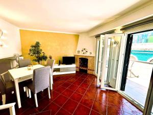 a living room with a table and a fireplace at Casa do Mar & Sesimbra Center View in Sesimbra