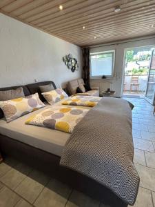 a bedroom with two beds and a couch at Gästehaus Ingrid in Ramsthal