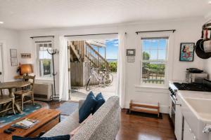 a person sitting on a couch in a living room at Waterfront with Private Beach Stunning Views in Provincetown
