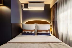 a bedroom with a large bed with a light above it at Leonardo Boutique Hotel The Lancaster Amsterdam in Amsterdam