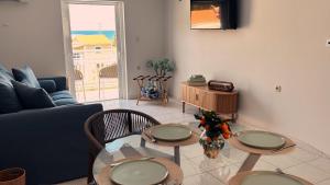 a living room with two tables and a couch at Abela Family Hotel in Argassi