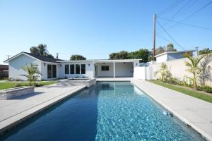 a swimming pool in front of a house at Beautiful Home with 4 bedroom, 2 bathrooms-full amenities in Orange