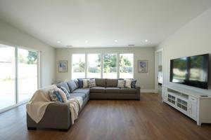 a living room with a couch and a flat screen tv at Beautiful Home with 4 bedroom, 2 bathrooms-full amenities in Orange