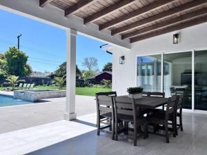 a dining room with a table and chairs on a patio at Beautiful Home with 4 bedroom, 2 bathrooms-full amenities in Orange
