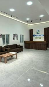 a room with couches and a table and a sign at Econom Hostel Ganja in Ganja +21 photos