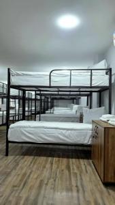 two bunk beds in a room with a wooden floor at Econom Hostel Ganja in Ganja