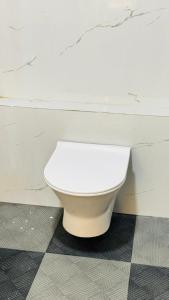 a bathroom with a white toilet in a room at Hotel shree lodging in Jogeshwāri