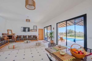 a living room with a large window and a pool at 3Moon Guesthouse in Aït Yassine