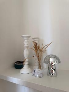 a shelf with vases and a lamp and a book at GJ Holiday Escapes - Le plage de Notre-Dame - Appartement au coeur de la vieille ville in Boulogne-sur-Mer