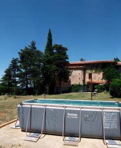 a swimming pool in front of a building at Col Di Metino - Umbria in Gualdo Tadino
