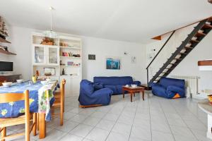 a living room with blue couches and a table at Casa Violina - Portoferraio in Portoferraio