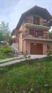 a house with a balcony and a garage at Holiday house Šadrvan Sarajevo in Hadžići +6 photos