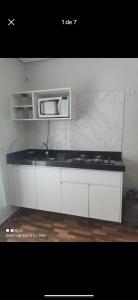 a kitchen with a counter top with a microwave at Residencial Beatriz centro in Formosa