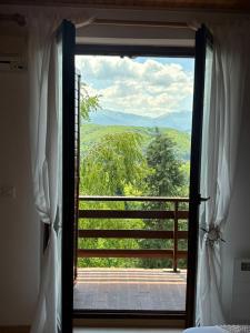 an open door to a balcony with a view at Holiday house Šadrvan Sarajevo in Hadžići
