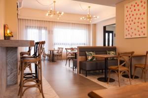 a restaurant with tables and chairs and a bar at Buluba - Dao Jia in Yuanshan