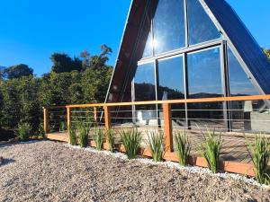 a glass building with plants in front of it at Paradise In Coffee in Socorro