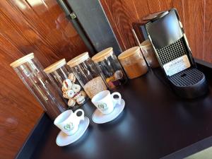 a table with a laptop and coffee cups on it at Paradise In Coffee in Socorro