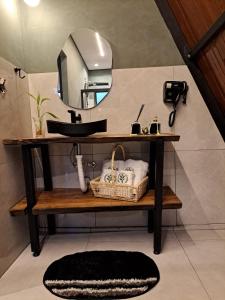 a bathroom with a sink and a mirror at Paradise In Coffee in Socorro