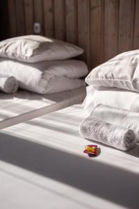 a group of white beds with towels and pillows at Poilsio namai El Nido in Nida