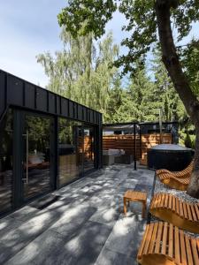 a patio with a bench and a house at Domki Na Talerzu in Skorochow