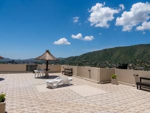 a patio with benches and a view of a city at Torre Melos, 2do piso, centro, con cochera in Villa Carlos Paz