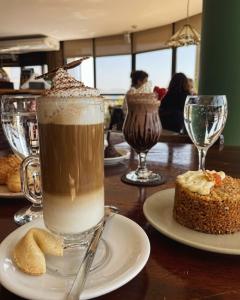 a table with a cup of coffee and a cake at Torre Melos, 2do piso, centro, con cochera in Villa Carlos Paz +16 photos
