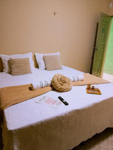 a bedroom with a bed with a towel on it at Bom Viver Pousada ltda in Viçosa do Ceará +11 photos