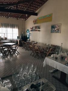 a room with tables and chairs and wine glasses at Bom Viver Pousada ltda in Viçosa do Ceará