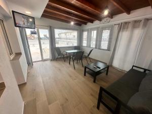 a living room with a couch and a table at VILLA HARIKLIA in Paralia Katerinis