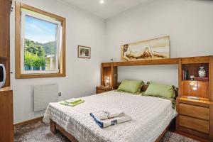 a bedroom with a large bed and a window at Casa da Giesta in Roge