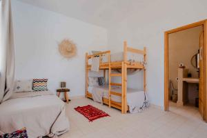 a bedroom with two bunk beds and a mirror at 3Moon Guesthouse in Aït Yassine +15 photos