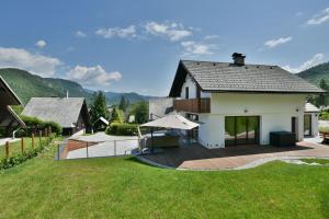 a house with a large backyard with a deck at Villa Belica in Bohinj