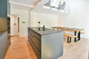 a kitchen with a counter and a dining table at Villa Belica in Bohinj +17 photos