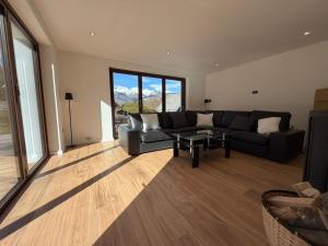 a living room with a couch and a table at Villa Belica in Bohinj