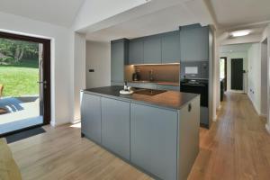 a kitchen with white cabinets and a counter top at Villa Belica in Bohinj